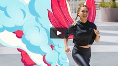 a woman in black shirt and leggings running next to wall with dragon painting on it