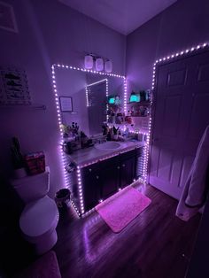 a bathroom with purple lights on the wall