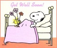 a cartoon dog laying in bed with flowers on the pillow and text get well soon