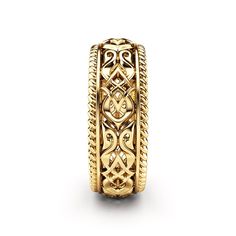 an intricate gold ring on a white background