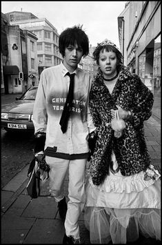 a man and woman walking down the street