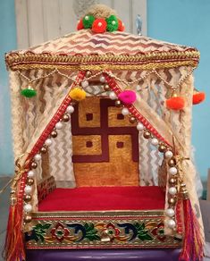 an elaborately decorated bed with tassels and beads