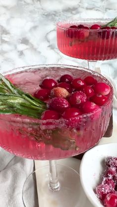 two glasses filled with cranberry punch and garnished with mint