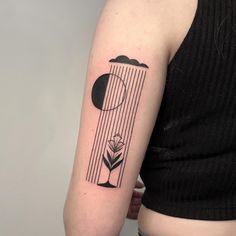 a woman's arm with a black and white tattoo on it