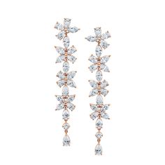 Add a touch of elegance to your wardrobe with our exquisite Long Floral Diamond Earrings, crafted in 18k white gold. The stylish drop design features a stunning floral motif, adorned with dazzling diamonds that effortlessly catch the light with every move. Diamond Flower-shaped Earrings For Formal Occasions, Luxury Flower-shaped Diamond Earrings For Formal Occasions, Exquisite Diamond Flower-shaped Earrings, Luxury White Diamond-cut Chandelier Earrings, Fine Jewelry Flower-shaped Cluster Earrings In Cubic Zirconia, Drops Design, Floral Motif, Diamond Earrings, White Gold