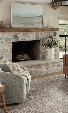 a living room filled with furniture and a fire place under a painting on the wall