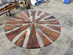 a wooden table sitting on top of a cement floor