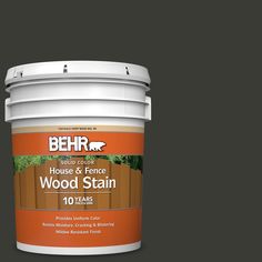 behr paint's house and fence wood stain is shown in an open bucket