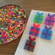 there is a plastic bead pattern next to a metal bowl with beads on it