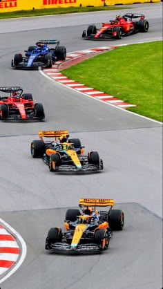 three racing cars driving on a race track