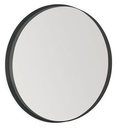 a black and white circular mirror on a wall