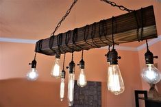 several light bulbs are hanging from a beam