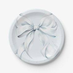 a paper plate with a white bow on it