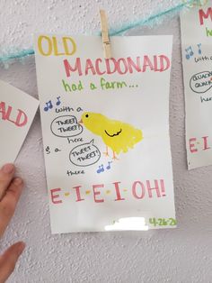 two handmade signs hanging on a wall with clothes pins attached to them, one has a drawing of a chicken and the other says old mcdonald had a farm