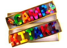 two open boxes with magnets that spell out the word camp kits