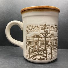 a coffee mug with a drawing of a house on it