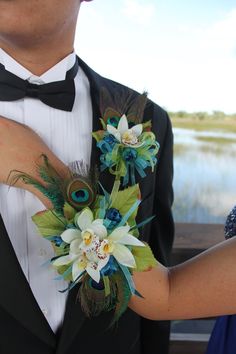 a close up of a person wearing a tuxedo and boutonniere