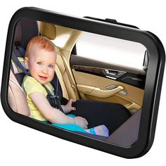 a baby sitting in a car seat with the rear view mirror on it's side