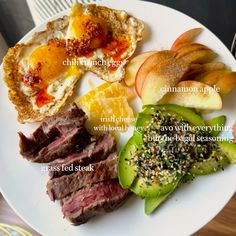 a white plate topped with meat, fruit and an egg on top of toasted bread