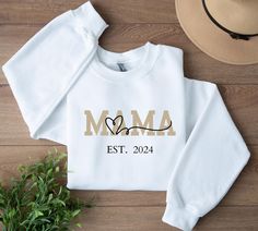 Custom Mama est Sweatshirt, Momma Sweatshirt, Mother Day Gift, Mama Sweater, Baby Announcement Gifts, New Mom Gifts Celebrate the joy of motherhood with this Personalized Mom Sweatshirt! This cozy and stylish custom crewneck is the perfect way to honor the special bond between you and your children. Featuring your child's name and birth year, it's a heartwarming keepsake that lets you wear your love proudly. ✨ Why This Sweatshirt is a Must-Have: Personalized Just for You: Customize this sweatshirt with your child's name and birth year, making it a unique and meaningful piece to cherish forever. Stylish Family Design: Showcase your pride as a mom with a timeless design that features your child's name and special year - a personal touch that adds warmth to any outfit. Super Soft & Cozy Fabri Momma Sweatshirt, Baby Announcement Gifts, New Mom Gifts, Custom Crewneck, Mama Sweater, Family Design, Mother Day Gift, Birth Year