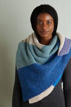 a woman wearing a blue and white striped scarf