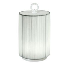 a white canister with a metal lid