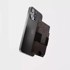 an iphone case is held up in the air with its phone holder attached to it