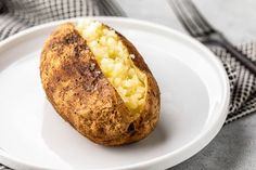 a baked potato sitting on top of a white plate