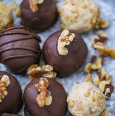 chocolate candies with walnuts and pecans on a silver platter, ready to be eaten