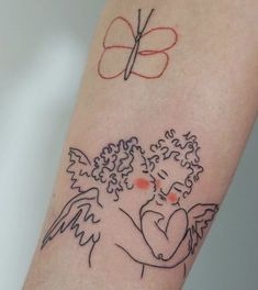 a tattoo on the arm of a woman with an angel and a butterfly above her head