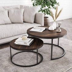 two coffee tables sitting on top of a rug in front of a couch and table