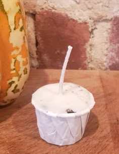 a paper cup with a straw sticking out of it