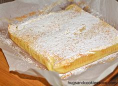 a pastry sitting on top of a piece of wax paper covered in powdered sugar