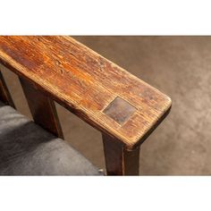 an old wooden bench sitting on top of a carpeted floor