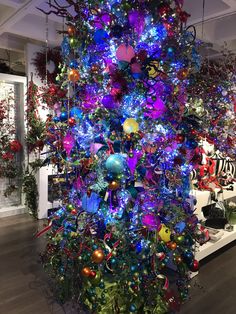 a brightly lit christmas tree in a store