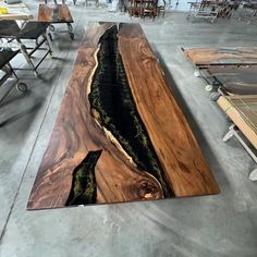 Indulge in opulence with our Black Resin Walnut Epoxy Table. Impeccably crafted, the deep hues of walnut seamlessly intertwine with the luxurious black resin rivers, creating a masterpiece that exudes sophistication. Elevate your space with this statement piece, where the allure of rich wood meets the modern elegance of resin, bringing a touch of lavishness to your surroundings. We offer seven wood types for you to choose from: Black Walnut, Zebrawood, Cunninghamia, Walnut Wood, Poplar Wood, Ash Black Walnut Epoxy Resin Table, Wood And Epoxy Table, Live Edge Bar Top, Ny House, Live Edge Bar, Epoxy River Table, Wood Ash, Epoxy Table, Epoxy Resin Table