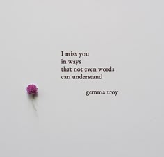 a pink flower sitting on top of a white wall next to a quote from genma troy