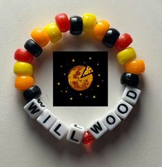 a beaded bracelet with the word wildwood written in white letters and colorful beads