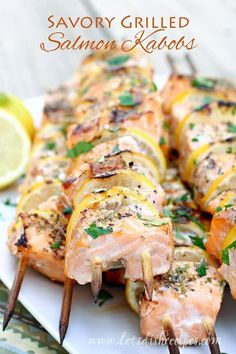 grilled salmon and lemon skewers on a white plate