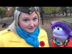 a woman standing next to a stuffed animal