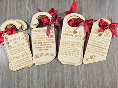 three wooden tags with red ribbons tied around them