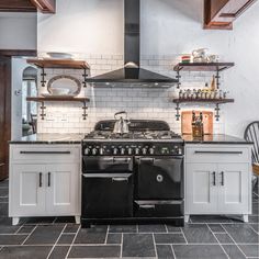 a stove top oven sitting inside of a kitchen