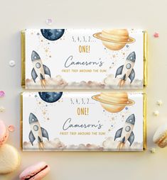 two candy bar wrappers with space theme