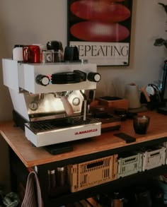 an espresso machine sitting on top of a wooden table