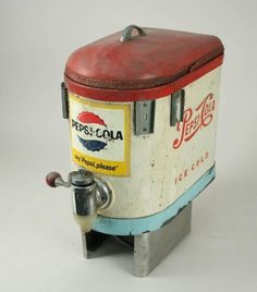 an old pepsi cola machine sitting on top of a table