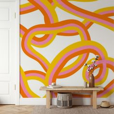 an orange and pink wall mural in a living room