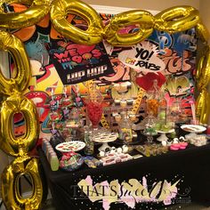 a table topped with lots of balloons and desserts