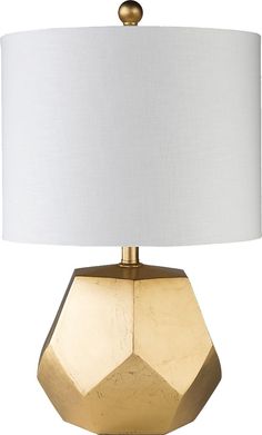 a gold table lamp with a white shade on it's base and a light bulb in the shape of an octagon