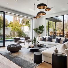 a living room filled with furniture and lots of windows