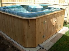 an outdoor hot tub in the middle of a yard